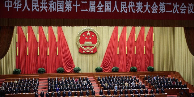 BEIJING, CHINA - MARCH 13: People attend the closing session of the National People's Congress (NPC) at the Great Hall of the People on March 13, 2014 in Beijing, China. During the congress China announced plans to raise its defense budget by 12.2 percent to 808.2 billion yuan (about 132 billion U.S. dollars) in 2014, about a quarter of the U.S military budget. (Photo by Lintao Zhang/Getty Images)