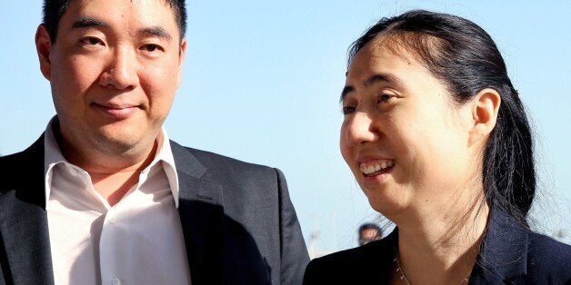 American couple Grace, right, and Matthew Huang arrive at the Hamad International Airport in Doha, Qatar, Sunday, Nov. 30, 2014. A Qatari appeals court on Sunday overturned a ruling against an American couple over the death of their adopted daughter and said they are free to leave, ending a closely watched legal saga that may have stemmed from cultural misunderstandings in the conservative Gulf nation. (AP Photo/Osama Faisal)
