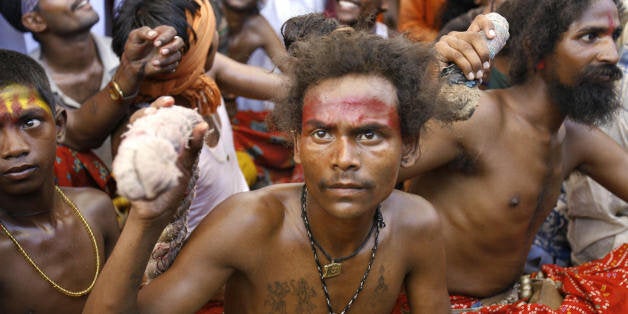 Mumbai, INDIA: Hindu dalits sit during a mass conversion to Buddhism ceremony in Mumbai, 27 May 2007. Thousands of low-caste and tribal Hindus, seeking freedom from oppression in India's heirarchy-ridden caste system, embraced Buddhism in a mass conversion. It is estimated that close to five thousand dalits - who are on the bottom rung of India's anicent caste hierarchy - would have converted to Buddhism during the simple ceremony during which the people recite hymns read out by the monks, following which they are accepted as Buddhists. AFP PHOTO/ Sajjad HUSSAIN (Photo credit should read SAJJAD HUSSAIN/AFP/Getty Images)