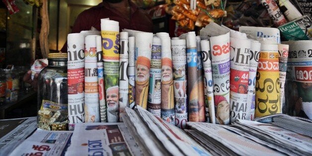 Indian newspapers with front pages featuring opposition leader Narendra Modi are on display at a stall in Bangalore, India, Saturday, May 17, 2014. Modi will be India's next prime minister, winning the most decisive victory the country has seen in more than a quarter century and sweeping the long-dominant Congress party from power, results showed Friday. (AP Photo/Aijaz Rahi)