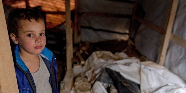 A young Syrian refugee looks on as he holds a hammer in a tent at the Al-Nihaya camp in the eastern Lebanese town of Arsal on October 23, 2014. With more than 1.1 million Syrian refugees, Lebanon has the most refugees per capita in the world, and the influx has created some resentment in a country of four million already facing economic and political challenges. AFP PHOTO / Maya Hautefeuille (Photo credit should read Maya Hautefeuille/AFP/Getty Images)