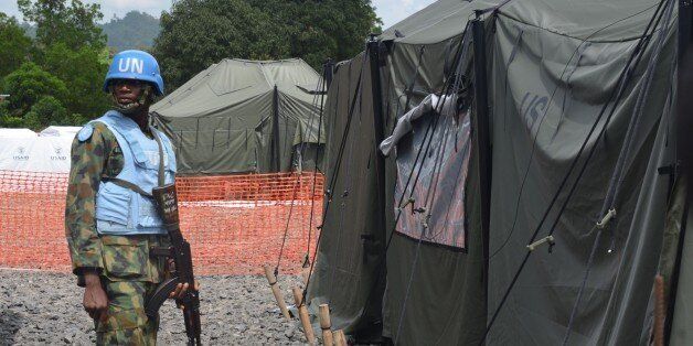 An UN soldier stands in front of a tent in the new Ebola Treatment Center US built by the United States army on November 10, 2014 in Tubmanburg, the provincial capital of Bomi County in western Liberia. Bomi County has been one of the high-hit region by the deadly virus Ebola. In West Africa, underfunded health systems have been crippled by the disease, which has spiraled out of control and infected more than 13,000 people. AFP PHOTO/ZOOM DOSSO (Photo credit should read ZOOM DOSSO/AFP/Getty Images)