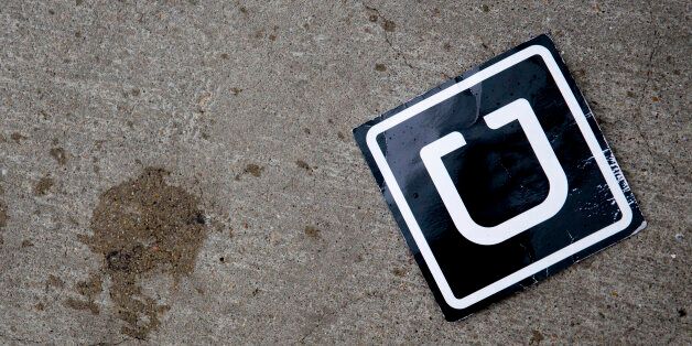 The Uber Technologies Inc. logo is seen on the ground at Ronald Reagan National Airport (DCA) in Washington, D.C., U.S., on Wednesday, Nov. 26, 2014. Uber Technologies Inc. investors are betting the five-year-old car-booking app is more valuable than Twitter Inc. and Hertz Global Holdings Inc. Photographer: Andrew Harrer/Bloomberg via Getty Images