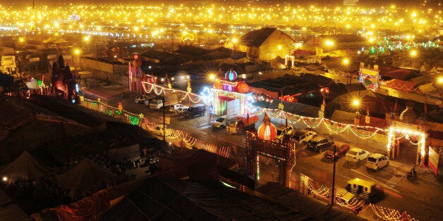 Temporary tents for devotees are pictured at dusk at Sangam, the confluence of the Rivers Ganges, Yamuna and mythical Saraswati, during the Maha Kumbh Mela in Allahabad on February 13, 2013. The Kumbh Mela in the town of Allahabad will see up to 100 million worshippers gather over 55 days to take a ritual bath in the holy waters, believed to cleanse sins and bestow blessings. AFP PHOTO/SANJAY KANOJIA (Photo credit should read Sanjay Kanojia/AFP/Getty Images)