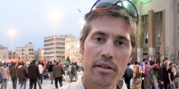FILE - This undated file still image from video released April 7, 2011, by GlobalPost, shows James Foley of Rochester, N.H., a freelance contributor for GlobalPost, in Benghazi, Libya. A Libyan government spokesman says four journalists detained since early April have completed an administrative hearing and will be released Tuesday or Wednesday.(AP Photo/GlobalPost, File)