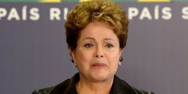 Brazilian President Dilma Rousseff cries while delivering a speech during the ceremony presenting the final report of the National Truth Commission (CNV) --which investigates those responsible for human rights violations between 1946 and 1988 in the country-- at the Planalto Palace in Brasilia, Brazil, on December 10, 2014. The report lists those responsible for political repression and admits --for the first time-- the disappearance of 434 people during the dictatorship. The disclosure of the document accompanies the International Human Rights Day commemoration. It also includes a list of places where forced interrogation, illegal arrests and enforced disappearances took place. AFP PHOTO/EVARISTO SA (Photo credit should read EVARISTO SA/AFP/Getty Images)