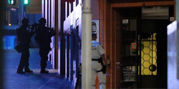 SYDNEY, AUSTRALIA - DECEMBER 15: Police surround the Lindt Chocolate Cafe, Martin Place during a hostage standoff on December 15, 2014 in Sydney, Australia. Police stormed the Sydney cafe as a gunman had been holding hostages for 16 hours. (Photo by Joosep Martinson/Getty Images)