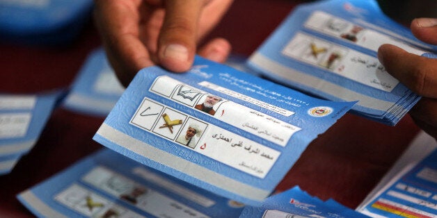An Afghan election commission worker sort ballots for an audit of the presidential run-off votes at an election commission of