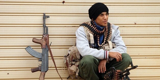 A fighter loyal to Khalifa Haftar, a retired general and former chief of staff for Moamer Kadhafi, takes a break as they figh