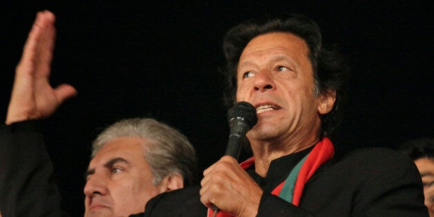 Pakistan's cricketer-turn-politician Imran Khan, leader of Pakistan Tehreek-e-Insaf party, addresses to his supporters during a sit-in protest in Islamabad, Pakistan, Wednesday, Dec. 17, 2014. Khan decided to end his party's monthslong sit-in protests in the capital following Tuesday's terrorist attack on a military-run school in Peshawar. (AP Photo/Anjum Naveed)