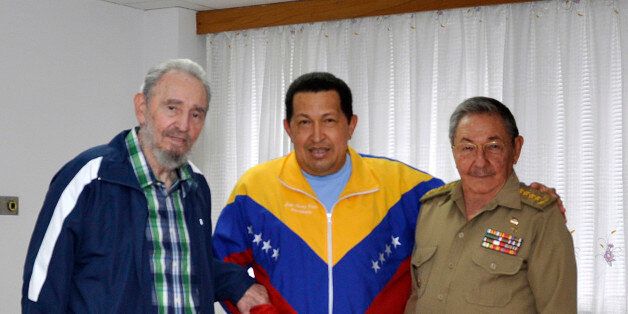 In this photo taken Friday June 17, 2011 and released by Granma newspaper, Cuba's former President Fidel Castro, left, and brother Cuba's President Raul Castro, right, stand with Venezuela's President Hugo Chavez at a hospital in Havana, Cuba. Chavez underwent surgery in Cuba for a pelvic abscess. (AP Photo/Granma)