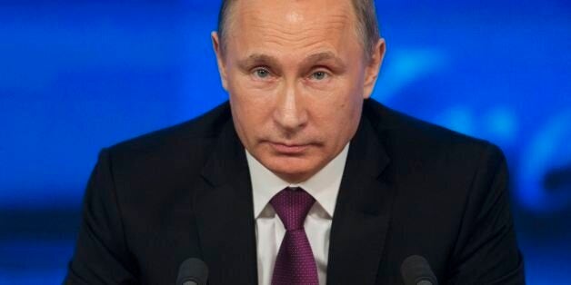 Russian President Vladimir Putin listens during his annual news conference in Moscow, Russia, Thursday, Dec. 18, 2014. The Ru