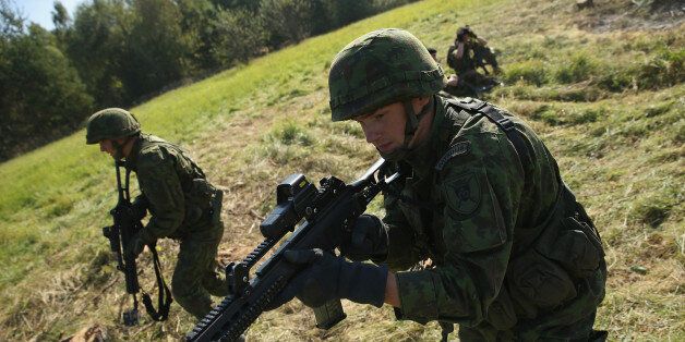 YAVOROV, UKRAINE - SEPTEMBER 17: Soldiers from Lithuania counter-attack in an ambush by Ukrainan soldiers on the third day of the 'Rapid Trident' bilateral military exercises between the United States and Ukraine that include troops from a variety of NATO and non-NATO countries on September 17, 2014 near Yavorov, Ukraine. Ukrainian President Petro Poroshenko is scheduled to travel to Washington tomorrow to appeal for more economic and military aid for his country burdened by the pro-Russian insurgency in eastern Ukraine. (Photo by Sean Gallup/Getty Images)