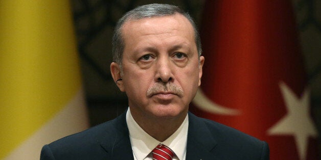 Turkish President Recep Tayyip Erdogan listens to Pope Francis during a meeting at the Presidential palace in Ankara, Turkey, Friday, Nov. 28, 2014. Under heavy security measures Pope Francis arrived in Turkey for a three-day visit and he met with Erdogan at his huge new palace on once-protected farm land and forest in Ankara, becoming the first foreign dignitary to be hosted at the lavish, 1000-room complex. (AP Photo/Burhan Ozbilici)