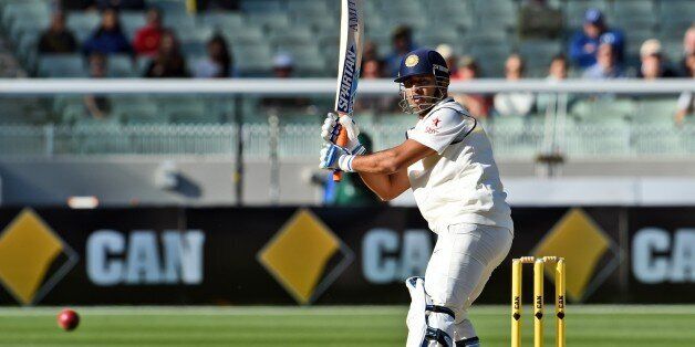 Indian batsman Mahendra Singh Dhoni plays a shot during the final day of the third cricket Test match against Australia at the Melbourne Cricket Ground (MCG) in Melbourne on December 30, 2014. AFP PHOTO/William WEST --IMAGE RESTRICTED TO EDITORIAL USE - STRICTLY NO COMMERCIAL USE-- (Photo credit should read WILLIAM WEST/AFP/Getty Images)