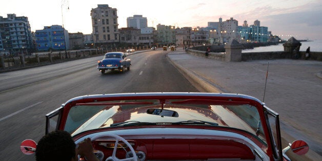 In this Sunday, Dec. 21, 2014 photo, Michel Salgado drives his 1957 Mercury Monterey convertible along the Malecon in Havana, Cuba. After U.S. car sales were banned in Cuba in 1959, Cubans have been have been forced to patch together Fords, Chevrolets and Chryslers that date back to before Fidel Castro's revolution, which can make it appear like the country is stuck in a 1950's time warp. (AP Photo/Desmond Boylan)