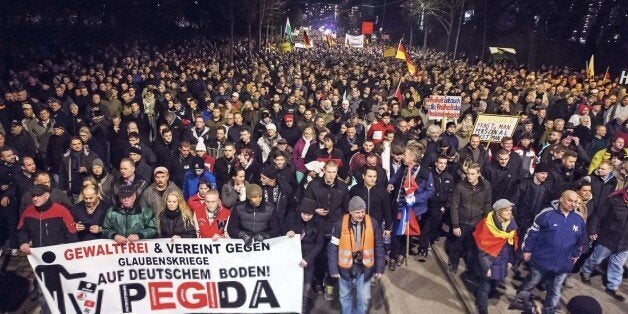 Thousands of participants of a rally called 'Patriotic Europeans against the Islamization of the West' (PEGIDA) gather in Dresden, eastern Germany, Monday, Dec. 15, 2014. The words at the banner read: 'Nonviolent and united against faith wars in Germany - Pegida'. Pegida, a nascent anti-foreigner campaign group, is growing in stature week by week and sparking concern among German officials. For the past nine weeks, activists protesting Germanyâs immigration policy and the spread of Islam in the West have been marching each Monday. (AP Photo/Jens Meyer)