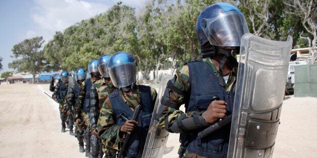 Somali police with full combat gear march at the police academy compound during the 71st anniversary of the police force, in Mogadishu, Somalia, Saturday, Dec. 20, 2014. (AP Photo/Farah Abdi Warsameh)