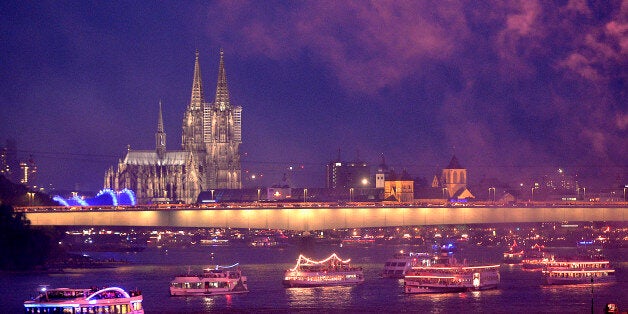 In this picture made available Sunday July 14, 2013, illuminated ships cruising on the river Rhine in front of the old town of Cologne with the town's landmark Cologne Cathedral , in Cologne, Germany, Saturday night, July, 13, 2013. (AP Photo/Martin Meissner)