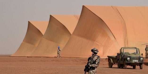 A Spanish soldier of the detachment of the Operation Barkhane stands guard at a French base outside the northern Malian city