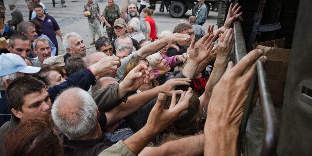 NIKOLAYEVKA, UKRAINE - 2014/07/06: The people waiting for their turn to have goods. The people of Slaviansk get the humanitarian aid from Ukrainian soldiers after the Pro-Russian rebels were kicked-out from Kiev. (Photo by Sergii Kharchenko/Pacific Press/LightRocket via Getty Images)