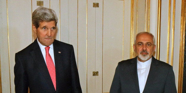 U.S. Secretary of State John Kerry and Iranian Foreign Minister Mohammad Javad Zarif, right, pose for a photograph prior to a bilateral meeting of the closed-door nuclear talks with Iran in Vienna, Austria, Sunday, Nov. 23, 2014. The U.S. and five other nations trying to negotiate a nuclear deal with Iran are turning away from attempting to reach an agreement by deadline and have started internal discussions on extending the talks, diplomats said Sunday. (AP Photo/Ronald Zak, pool)