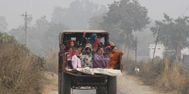 JAMMU, INDIA - JANUARY 3: Villagers sit in the back of a vehicle as they flee their homes fearing firing from the Pakistan si