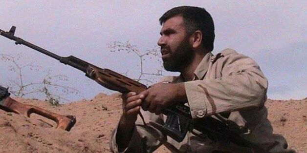 In this undated photo provided by an anti-Bashar Assad activist group Edlib News Network (ENN), which has been authenticated based on its contents and other AP reporting, shows Jamal Maarouf, the head of the rebel Syrian Revolutionaries Front, holding a rifle, in Idlib province, northern Syria. The moderate Syrian rebels that Washington hopes will battle the Islamic State extremist group are hemorrhaging on multiple fronts. In a key battle earlier this month they rapidly collapsed in the face of an assault by al-Qaida fighters, with some rebels surrendering their weapons and others outright defecting to the extremists. (AP Photo/Edlib News Network ENN)