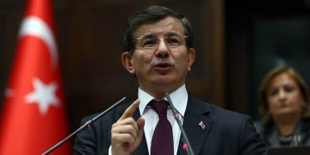 Turkey's Prime Minister Ahmet Davutoglu delivers a speech during the parliamentary group meeting of Turkey's ruling Justice a