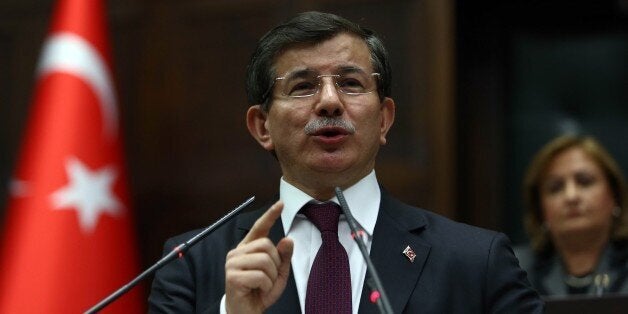 Turkey's Prime Minister Ahmet Davutoglu delivers a speech during the parliamentary group meeting of Turkey's ruling Justice and Development Party at the Grand National Assembly of Turkey (TBMM) on January 6, 2015 in Ankara. AFP PHOTO/ADEM ALTAN (Photo credit should read ADEM ALTAN/AFP/Getty Images)