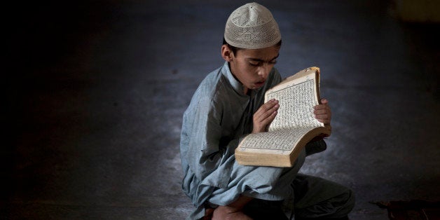 A Pakistani student of a madrassa, or Islamic school, attends a test in reciting verses of the Quran, during the Muslim holy fasting month of Ramadan, in a Mosque in Islamabad on Monday, July 22, 2013. Muslims throughout the world are marking the month of Ramadan, the holiest month in Islamic calendar. (AP Photo/Muhammed Muheisen)