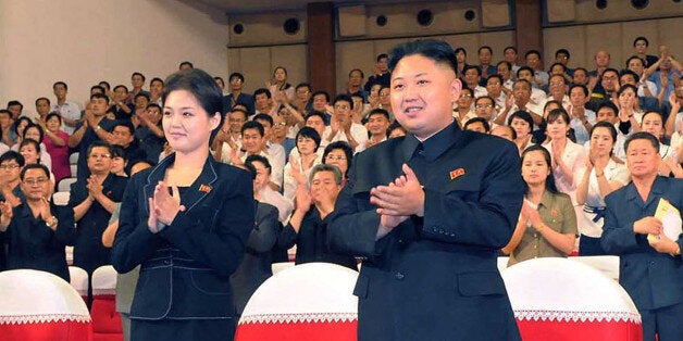 (FILES) This file picture taken on July 6, 2012 by North Korean official Korean Central News Agency and released on July 9 shows North Korean leader Kim Jong Un (C), accompanied by a young woman (L), enjoying a demonstration performance given by the newly organized Moranbong band in Pyongyang. North Korean state television on July 25, 2012 confirmed that leader Kim Jong-Un is married and named his wife as Ri Sol-Ju, South Korea's unification ministry said. South Korea's unification ministry said it appeared that Ri was the woman who has been pictured several times at Kim's side at public events in recent weeks. AFP PHOTO / KCNA via KNS / FILES ---EDITORS NOTE--- RESTRICTED TO EDITORIAL USE - MANDATORY CREDIT 'AFP PHOTO / KCNA VIA KNS' - NO MARKETING NO ADVERTISING CAMPAIGNS - DISTRIBUTED AS A SERVICE TO CLIENTS (Photo credit should read KNS/AFP/GettyImages)