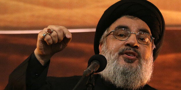 Hezbollah leader Sheik Hassan Nasrallah addresses supporters ahead of the Shiite Ashura commemorations, in the southern suburb of Beirut, Monday, Nov. 3, 2014. The head of the Shiite militant group, whose forces are fighting in Syria alongside the troops of President Bashar al-Assad, usually addresses supporters via video link, and had not appeared in public since July. (AP Photo/Hussein Malla)