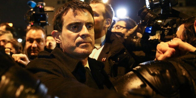 PARIS, FRANCE - JANUARY 10: French Prime Minister Manuel Valls greets the crowd at the site of the attack on a kosher market on January 10, 2015 in Paris, France. Four hostages and three suspects were killed when police ended two separate sieges at a kosher supermarket and a printing company on an industrial estate, following Wednesday's deadly attack on Charlie Hebdo magazine. A fourth suspect, Hayat Boumeddiene, 26, escaped and is wanted in connection with the murder of a policewoman. (Photo by Richard Bord/Getty Images)