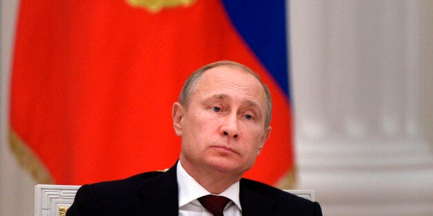 In this photo taken on Tuesday, Dec. 9, 2014, Russian President Vladimir Putin heads a meeting in Moscow's Kremlin, Russia. (