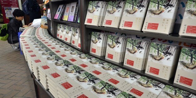 Customers read books by Japanese author Haruki Murakami as Murakami's new novels of the book 'Onna no Inai Otokotachi' which can be translated as 'Men Without Women' are displayed at the Sanseido bookstore in Tokyo on on August 18, 2014. Haruki Murakami's first collection of short stories in nine years hit the shelves in Japan. AFP PHOTO / Yoshikazu TSUNO (Photo credit should read YOSHIKAZU TSUNO/AFP/Getty Images)