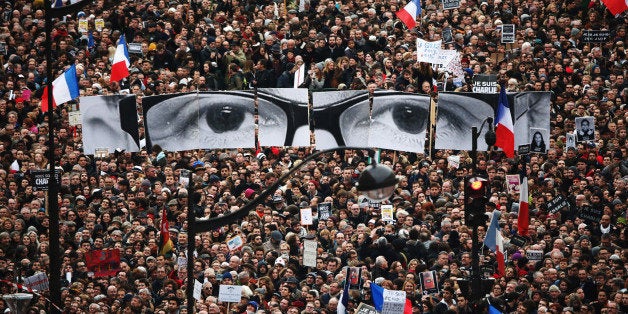 PARIS, FRANCE - JANUARY 11: Demonstrators make their way along Boulevrd Voltaire in a unity rally in Paris following the recent terrorist attacks on January 11, 2015 in Paris, France. An estimated one million people are expected to converge in central Paris for the Unity March joining in solidarity with the 17 victims of this week's terrorist attacks in the country. French President Francois Hollande will lead the march and will be joined by world leaders in a sign of unity. The terrorist atrocities started on Wednesday with the attack on the French satirical magazine Charlie Hebdo, killing 12, and ended on Friday with sieges at a printing company in Dammartin en Goele and a Kosher supermarket in Paris with four hostages and three suspects being killed. A fourth suspect, Hayat Boumeddiene, 26, escaped and is wanted in connection with the murder of a policewoman. (Photo by Christopher Furlong/Getty Images)