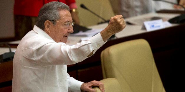 Cuba's President Raul Castro raises his fist and shout "Long live Fidel" during the closing of the twice-annual legislative session at the National Assembly in Havana, Cuba, Saturday, Dec. 20, 2014. While praising the historic agreement between Cuba and the U.S. to restore relations, Castro made it clear that the agreement only goes so far, reminding the audience of his call for the U.S. Congress to end the trade embargo. (AP Photo/Ramon Espinosa)