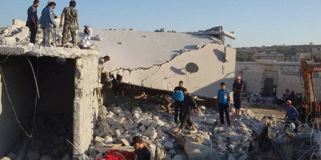 FILE - In this Tuesday Sept. 23, 2014 file photo provided by an anti-Bashar Assad activist group Edlib News Network (ENN), which has been authenticated based on its contents and other AP reporting, Syrian citizens check a damaged house that they say was targeted by the coalition airstrikes in the village of Kfar Derian, a base for the al-Qaida-linked Nusra Front, a rival of the Islamic State group, between the northern province of Aleppo and Idlib, Syria. U.S.-led coalition airstrikes against the Islamic State group and other extremists in Syria have killed more than 860 people, including civilians, since they began in mid-September, a monitoring group said Wednesday, Nov. 12. (AP Photo/Edlib News Network ENN, File)