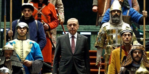 ANKARA, TURKEY - JANUARY 12: Turkish President Recep Tayyip Erdogan poses front of the 16 soldiers who represent the 16 Turkish states founded in the history during the visit of the Palestinian President Mahmoud Abbas (not seen) at the Turkish presidential palace in Ankara, Turkey on January 12, 2015. (Photo by Kayhan Ozer/Anadolu Agency/Getty Images)