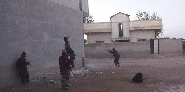 FILE - This undated file photo posted on Monday, Nov. 4, 2014 by the Raqqa Media Office of the Islamic State group, a militan