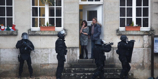 FILE â In this Thursday, Jan. 8, 2015, file photo, French police conduct house to house searches in Longpont, north of Paris, during the second day of a manhunt for the suspects in the newsroom massacre at the satirical French magazine, Charlie Hebdo. (AP Photo/Thibault Camus, File)