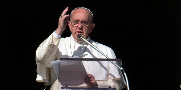 Pope Francis delivers his blessing during the Angelus noon prayer he celebrated from the window of his studio overlooking St. Peter's Square at the Vatican, Friday, Dec. 26, 2014. (AP Photo/Alessandra Tarantino)