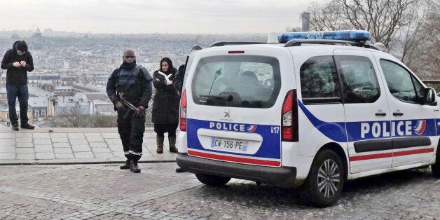 French police officers patrol around the Sacre Coeur basilica at Montmartre district, in Paris, Monday, Jan. 12, 2015. France on Monday ordered 10,000 troops into the streets to protect sensitive sites after three days of bloodshed and terror, amid the hunt for accomplices to the attacks that left 17 people and the three gunmen dead. (AP Photo/Jacques Brinon)