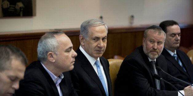 Israeli Prime Minister Benjamin Netanyahu listens during a weekly cabinet meeting in Jerusalem, Sunday, Jan. 18, 2015. (AP Photo/Abir Sultan, Pool)