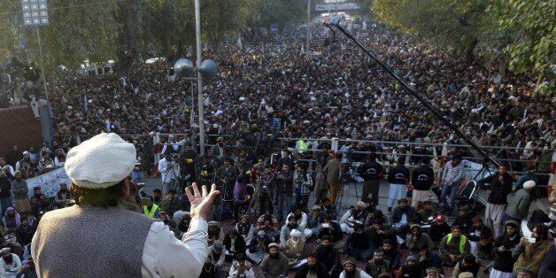 Hafiz Saeed, leader of Jamaat-ud-Dawah (JuD) Pakistan, addresses demonstrators during a protest against the printing of satirical sketches of the Prophet Muhammad by French magazine Charlie Hebdo, in Lahore on January 18, 2015. Anti-Charlie Hebdo protests continued across Pakistan as thousands of people came on streets in almost all major cities chanting slogans against the printing of cartoons of the Prophet Mohammed in the French magazine. AFP PHOTO / Arif ALI (Photo credit should read Arif Ali/AFP/Getty Images)