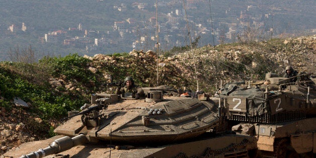 Israeli soldiers sit in tanks near the in Israel-Lebanon Border, northern Israel, Tuesday, Jan. 20, 2015. Israel is on high alert for possible attacks from the Lebanon-based militant group Hezbollah following an airstrike on Hezbollah fighters in Syria, Israeli defense officials said Tuesday. Israel has boosted deployment of its "Iron Dome" anti-missile aerial defense system along its northern frontier, which borders Lebanon and Syria, and has increased surveillance activities in the area, the officials said. Israel's Security Cabinet is scheduled to meet to discuss a potential escalation in violence, they said. (AP Photo/Ariel Schalit)