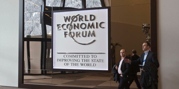 Participants walk in the main entrance hall of the Congress Center the day before the opening of the annual meeting of the World Economic Forum in Davos, Switzerland, Tuesday, Jan. 20, 2015. The world's financial and political elite will head this week to the Swiss Alps for 2015's gathering of the World Economic Forum at the Swiss ski resort of Davos. (AP Photo/Michel Euler)