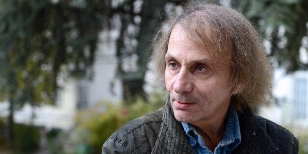 French writer Michel Houellebecq poses on November 5, 2014 during his photo exhibition 'Before Landing' at the Pavillon Carre