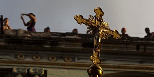 Catholic faithful watch the procession of Cuba's patron saint, the Virgin of Charity of Cobre, on her feast day, from the roo